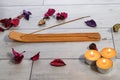 lighted incense stick in its stand with flower petals Royalty Free Stock Photo