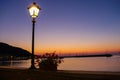 Lighted lantern on coast of the Tyrrhenian Sea on the sunset