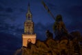 Lighted spire of the St. Marienchurch behind the Neptune`s Fountain in Berlin at night. Royalty Free Stock Photo