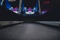 A lighted vintage Skee-Ball game in a darkened arcade Royalty Free Stock Photo