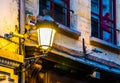 Lighted vintage street lantern on the wall of a city house, Flemish architecture, outdoor lighting Royalty Free Stock Photo