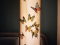 Lighted wall lamp with butterflies accessory decoration in front in detail