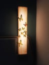 Lighted wall lamp with butterflies accessory decoration in front