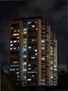 Lighted windows of homes of an HDB high-rise apartment block at night Royalty Free Stock Photo