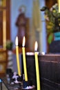 Lighted yellow candles on a prayer altar Royalty Free Stock Photo