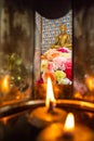 Lighten candles and beautiful colorful flowers to worship golden