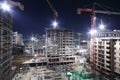 Lightening multi-storey buildings under construction and cranes Royalty Free Stock Photo