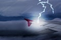 Lightening strikes aircraft wing of airplane on dark sky