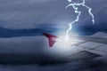 Lightening strikes Aircraft Wing of airplane on dark sky