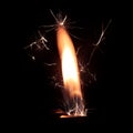 Lighter fire with sparks on black background