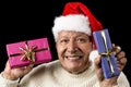 Lighthearted, Smiling Old Man Offering Two Gifts Royalty Free Stock Photo