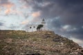 Kea island, Greece. Lighthhouse Tamelos on a rocky cliff, cloudy sky background Royalty Free Stock Photo