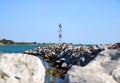 Lighthouse in Aegean Sea on rocks. Royalty Free Stock Photo