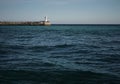 Lighthouse against the backdrop of a calm blue sea on a sunny day Royalty Free Stock Photo