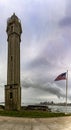Lighthouse and American flag of the maximum security federal prison of Alcatraz located in the middle of the San Francisco bay. Royalty Free Stock Photo