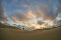 Lighthouse on beach with pretty sunset