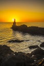 Lighthouse during a beautiful orange sunset in the Pasajes San Juan, Gipuzkoa, Spain Royalty Free Stock Photo
