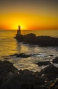 Lighthouse during a beautiful orange sunset in the Pasajes San Juan, Gipuzkoa, Spain Royalty Free Stock Photo