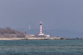 Red and white lighthouse on the Black Sea coast in the town of Chernomorsk Royalty Free Stock Photo