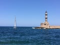 Lighthouse and boat in bay Royalty Free Stock Photo