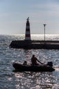 Lighthouse, boat, man and dog