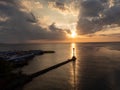 Lighthouse and a boat over the calm sea on sunset Royalty Free Stock Photo