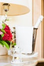 Lighthouse candle holder with champagne bottle and flower basket in the upscale hotel room. Being alone, getaway