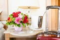 Lighthouse candle holder with champagne bottle, siutcase and flower basket in the upscale hotel room. Being alone