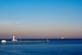 Lighthouse And Cargo Ship Leaving A Harbor