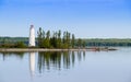 Lighthouse on Christian Island reflecting in the calm water