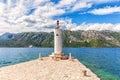 Lighthouse by the Church of Our Lady of the Rocks in the Adriatic sea, Bay of Kotor near Perast, Montenegro Royalty Free Stock Photo