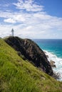 Lighthouse on a cliff by the sea. Vertical picture. Cape Byron. Byron Bay, New South Wales NSW, Australia Royalty Free Stock Photo