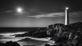 lighthouse on the coast black and white photo of Romantic lighthouse near Atlantic seaboard shining at night Royalty Free Stock Photo