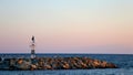 Lighthouse on the coast in sunset. Royalty Free Stock Photo