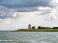 Lighthouse De Ven on dyke of IJsselmeer lake, Noord-Holland, Netherlands