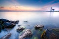 Lighthouse on the Dutch coast near the island of `marken` during sunrise on a large inland lake Royalty Free Stock Photo