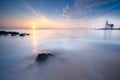 Lighthouse on the Dutch coast near the island of `marken` during sunrise on a large inland lake Royalty Free Stock Photo