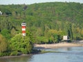 Lighthouse on the Elbe river bank with dense trees in Hamburg, Germany Royalty Free Stock Photo