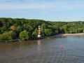 Lighthouse on the Elbe riverbank with dense trees in Hamburg, Germany Royalty Free Stock Photo