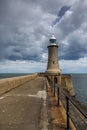 The Lighthouse at the end of the North Pier in Tynemouth, England, on a cloudy day Royalty Free Stock Photo