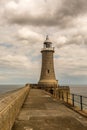 The Lighthouse at the end of the North Pier in Tynemouth, England, on a cloudy day Royalty Free Stock Photo