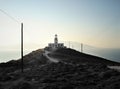 Lighthouse at the end of the road in Mykonos island Royalty Free Stock Photo