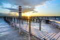 Lighthouse at the end of sea pier. Cold windy morning Royalty Free Stock Photo