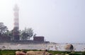 lighthouse in fog on coast