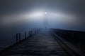 Lighthouse in a foggy night Royalty Free Stock Photo