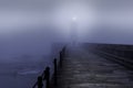 Lighthouse in a foggy night Royalty Free Stock Photo