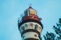 Lighthouse in the forest among the trees. red and white lighthouse Royalty Free Stock Photo