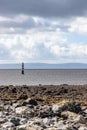 Lighthouse In Galway Bay With Rainy Cloud And Burren Mountains In Background