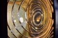 Lighthouse glass photographed at an angle showing concentric rings of thickened glass, to illuminate and magnify