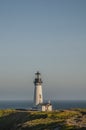 Lighthouse on a grassy cliff overlooking the Ocean Royalty Free Stock Photo